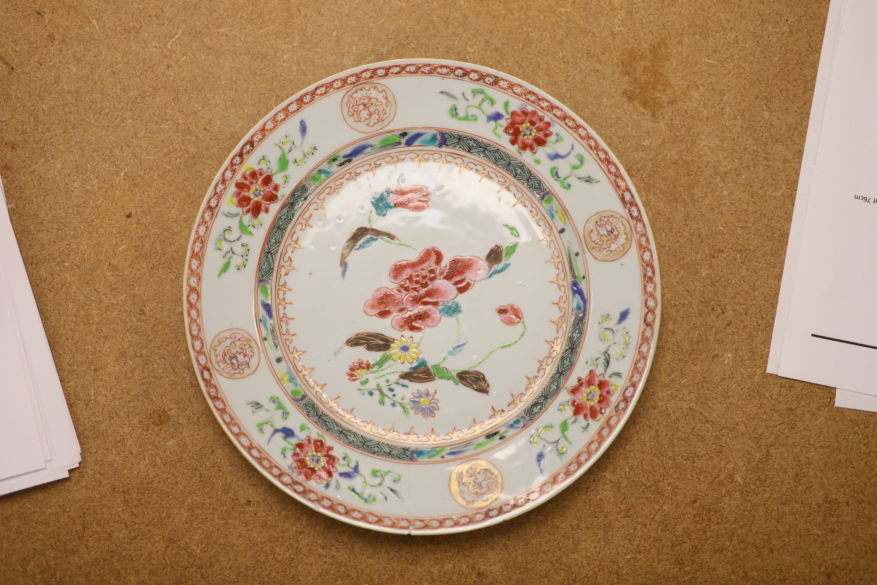 A pair of 18th century Chinese famille rose plates and another similar, largest diameter 22.5cm (damage)
